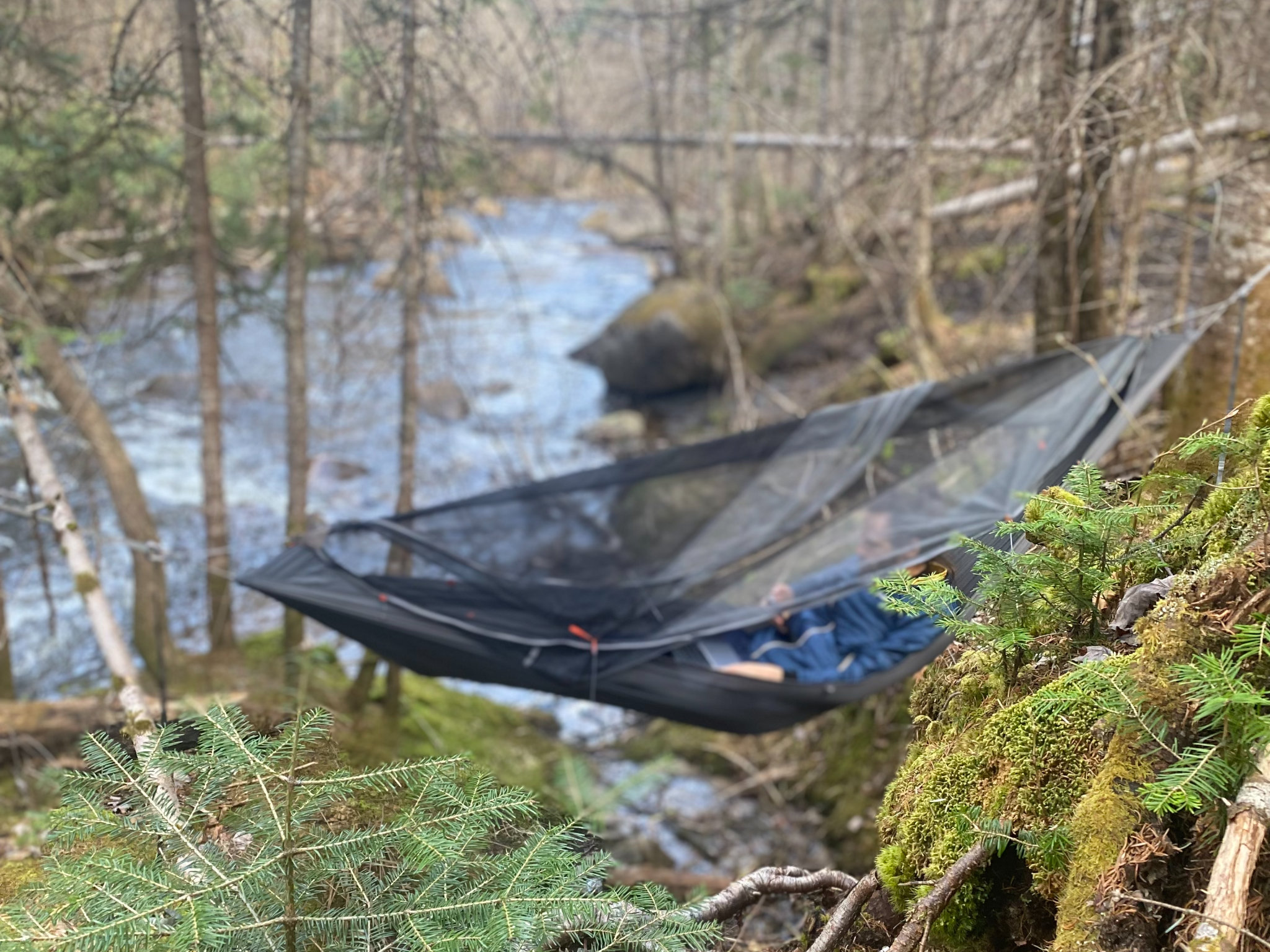 JD relaxing in a Kammok hammock by Rivière aux Pins